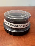 Leica Wild Surgical Microscope Dual Objective Lens 382168, F=300MM, 65MM Thread. Fixed Price $300.00.