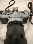 Olympus OM-1 Film Camera W/ Vivitar 75-205MM F3.8 Auto Focus Lens And Arm Sling. Fixed Price $110.00.