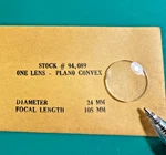 Edmund One Lens Plano Convex 24MM Diameter 105MM Focal Length *chipped*. Fixed Price $16.95.